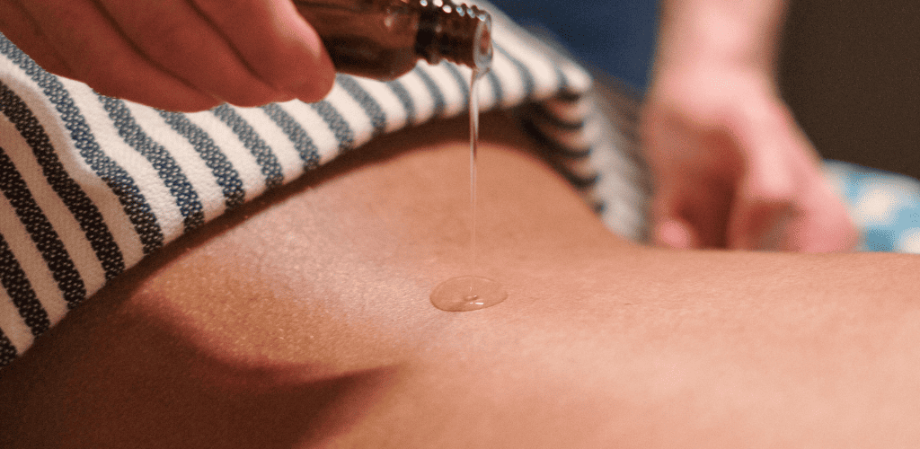 Warm oil being applied during a relaxing Thai massage in Greenock.